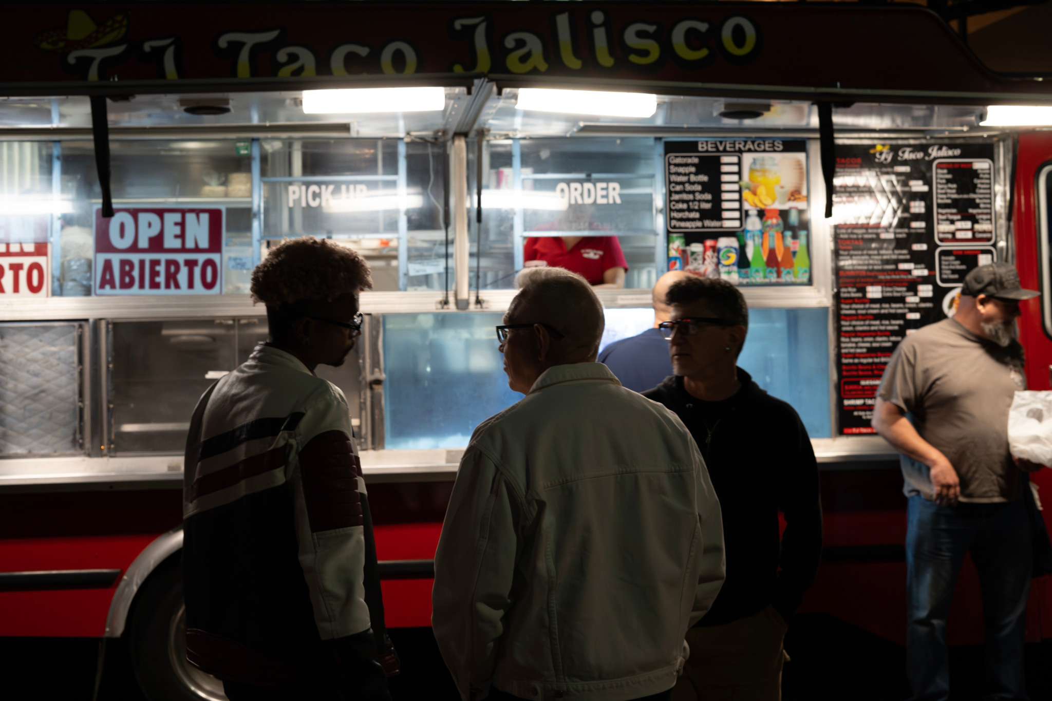 People gathered near a taco truck at a Vallejo community event.